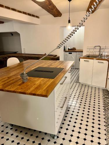a kitchen with white cabinets and a wooden counter top at Celle Old Town Hideaway in Celle