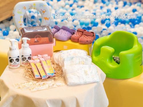 a table topped with a table with toys and a chair at Hotel Naturwald Furano in Furano