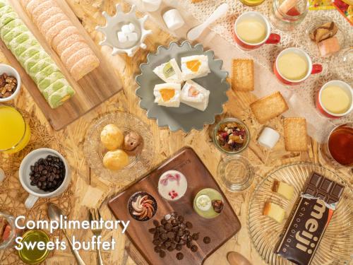 a table topped with lots of different types of food at Hotel Naturwald Furano in Furano