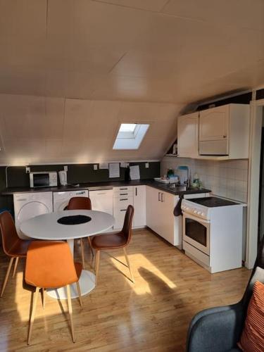 a small kitchen with a table and chairs in it at 2 etasje Jutulveien 6 in Tønsberg