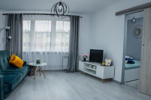 Televízia a/alebo spoločenská miestnosť v ubytovaní Lovely place-apartament Oświęcim
