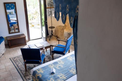 a living room with two blue chairs and a couch at Château de Trigance in Trigance