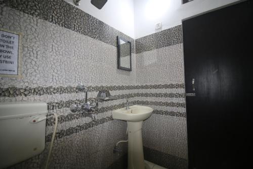 a bathroom with a sink and a toilet at Hashtagg hostel and hotel in Rishīkesh