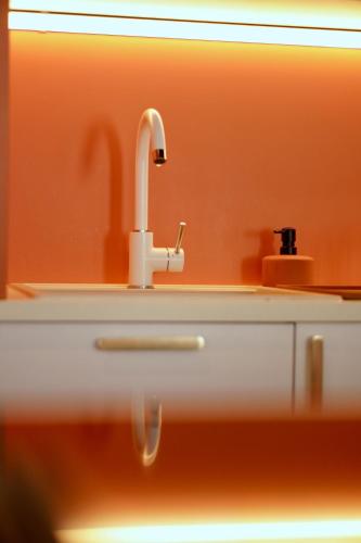 a white bathroom sink with a faucet at Roma Divine home cinéma et jardin in Nîmes