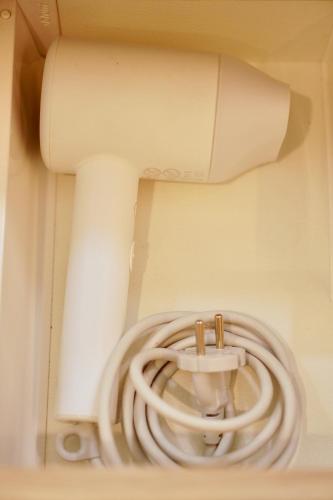 a white pipe in a room with a hose at Roma Divine home cinéma et jardin in Nîmes