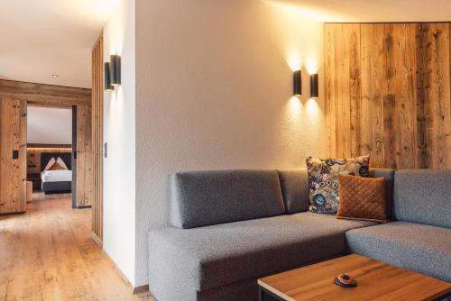 a living room with a couch and a bed at Hotel - Gasthof Märzenklamm in Stumm