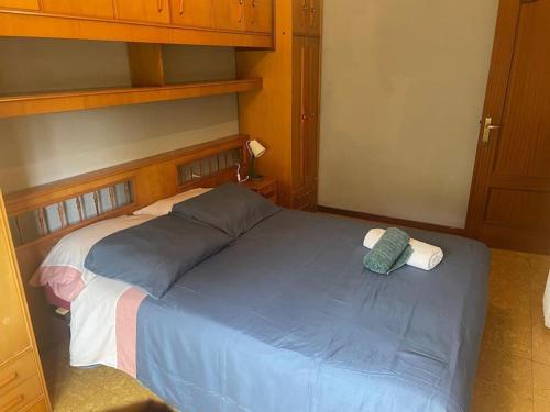 a bedroom with a blue bed with a wooden headboard at VUT Casa Albar in Soria