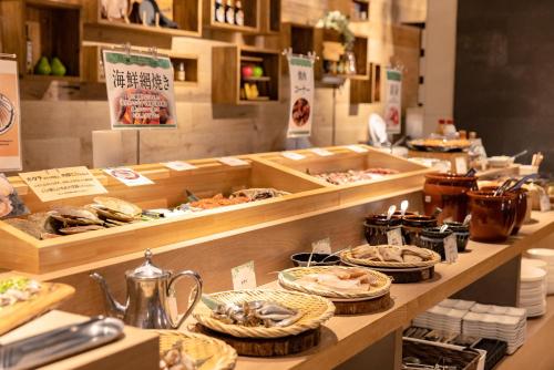 a buffet line with many different types of food at Hotel Naturwald Furano in Furano