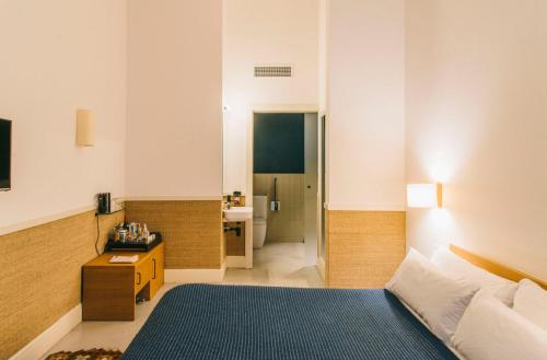a hotel room with a bed and a bathroom at Hotel Casa Bonay & Spa in Barcelona