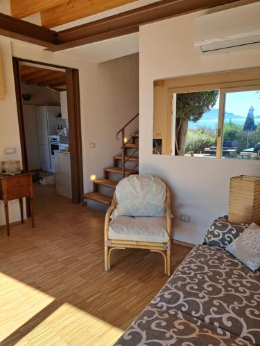Una sala de estar con una silla y una ventana. en Villa Nilla, en Tellaro