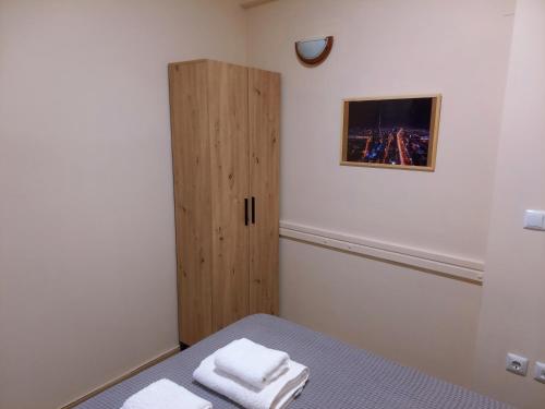 a bedroom with a bed and a wooden cabinet at Sam's View City Heart Tripoli - Beautiful Apartment With Backyard in Tripolis