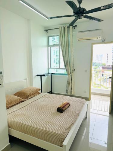 a bedroom with two beds and a ceiling fan at Spice Arena Service Apartment in Bayan Lepas