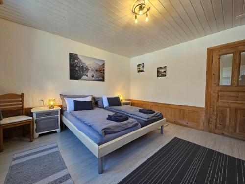 a bedroom with a bed and a desk and a window at Mountain Holiday in Wimmis