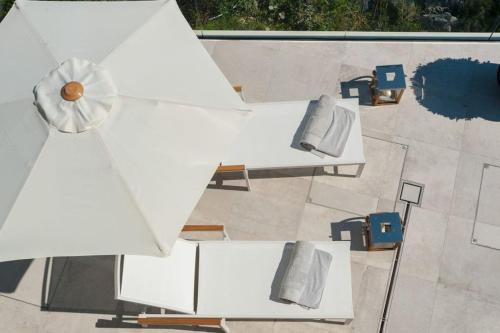 an overhead view of tables and chairs on a patio at Luxury Seafront Villa Prestige Brac with private pool, sauna and gym and private sea deck at the beach on Brac island in Selca