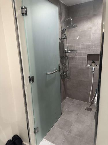 a shower with a glass door in a bathroom at Duba gold in Ḑubā
