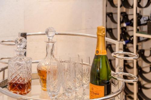 two bottles of wine and glasses on a metal tray at Luxury Seafront Villa Prestige Brac with private pool, sauna and gym and private sea deck at the beach on Brac island in Selca