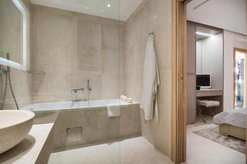 a bathroom with a tub and a sink at Luxury Seafront Villa Prestige Brac with private pool, sauna and gym and private sea deck at the beach on Brac island in Selca