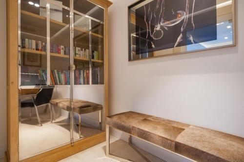 a room with a bench and a book shelf at Luxury Seafront Villa Prestige Brac with private pool, sauna and gym and private sea deck at the beach on Brac island in Selca