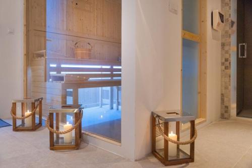 a room with a table and two chairs with lights at Luxury Seafront Villa Prestige Brac with private pool, sauna and gym and private sea deck at the beach on Brac island in Selca