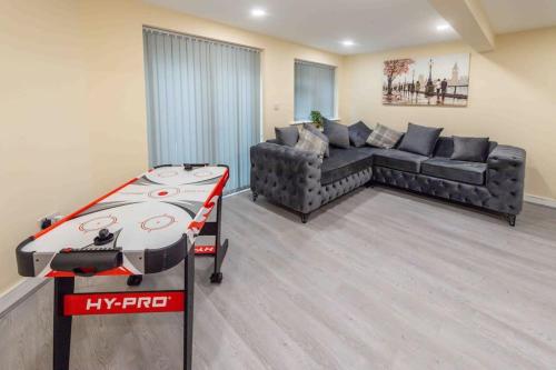 a living room with a couch and a table at Beautiful, Peaceful, 5 Bedroom home with Hot Tub! in Manchester