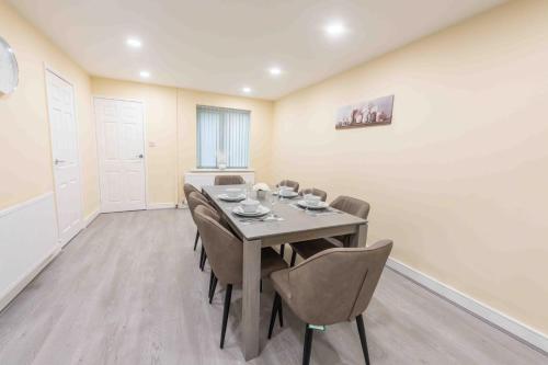 a dining room with a table and chairs at Beautiful, Peaceful, 5 Bedroom home with Hot Tub! in Manchester