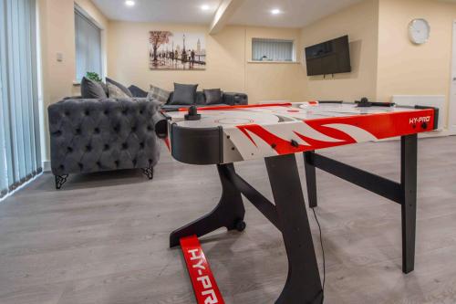 a ping pong table in a living room at Beautiful, Peaceful, 5 Bedroom home with Hot Tub! in Manchester