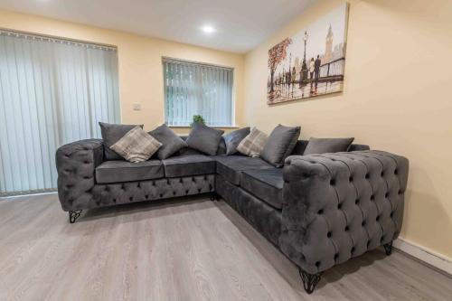 a large leather couch in a living room at Beautiful, Peaceful, 5 Bedroom home with Hot Tub! in Manchester