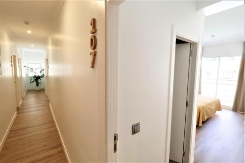 a hallway leading to a bedroom with a bed at Hotel Gabarda in Palmanova