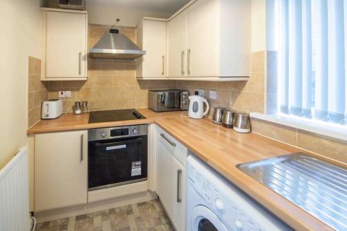 a kitchen with white cabinets and a counter top at Beautiful, Peaceful, 5 Bedroom home with Hot Tub! in Manchester