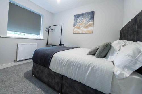 a bedroom with a large bed with a large window at Beautiful, Peaceful, 5 Bedroom home with Hot Tub! in Manchester