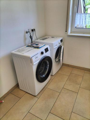 a washer and dryer in a corner of a room at Ferienwohnung Karin 65355 in Moormerland