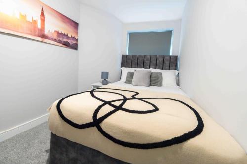 a bedroom with a large bed in a white room at Beautiful, Peaceful, 5 Bedroom home with Hot Tub! in Manchester