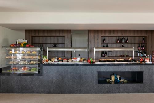 a kitchen with a counter with food on it at Atlantica Marmari Palace in Mastichari