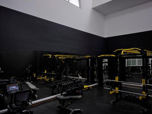 a gym with several weight machines in a room at Atlantica Marmari Palace in Mastichari