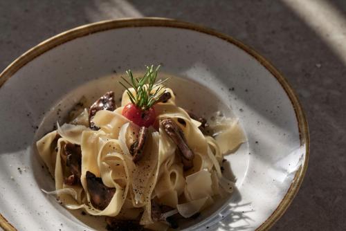 a bowl of pasta with a strawberry on top at Atlantica Marmari Palace in Mastichari