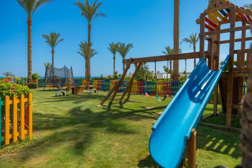 a blue slide in a playground with palm trees at Grand Oasis Resort in Sharm El Sheikh