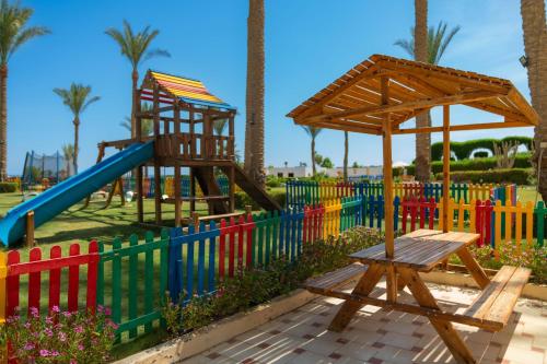 a playground with a slide and a swing set at Grand Oasis Resort in Sharm El Sheikh