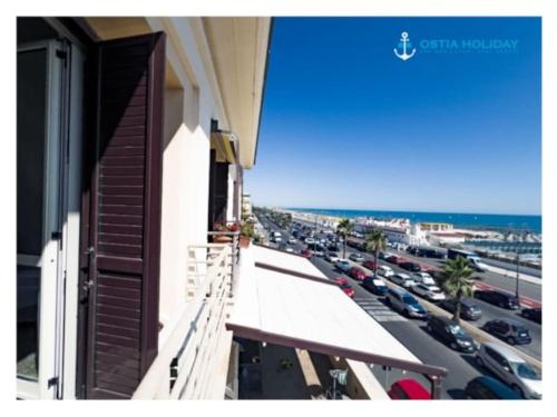a balcony of a building with a view of a parking lot at Ostia Holiday Al pontile 2 in Lido di Ostia