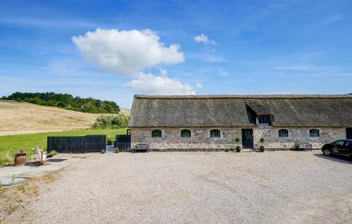 an old stone building with a thatched roof at Lovely Apartment In Nykøbing Sj in Lumsås
