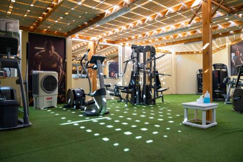 a gym with exercise equipment on a green floor at Grand Oasis Resort in Sharm El Sheikh