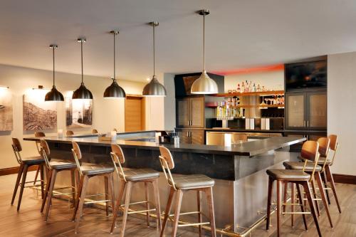 a kitchen with a bar with wooden stools at Residence Inn by Marriott Vail in Vail