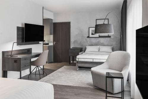 a bedroom with a bed and a desk and a chair at Residence Inn by Marriott Munich Ostbahnhof in Munich