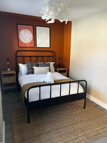 a bedroom with a large bed and a chandelier at Irene Suite By Koya Homes - 2-Bedroom Bungalow, Cardiff City Centre & Free Parking in Cardiff