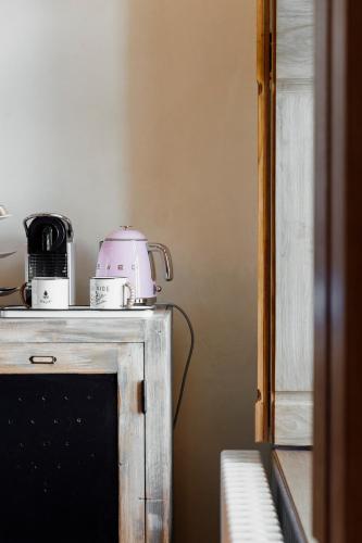 a appliance sitting on top of a counter in a kitchen at ÉCURIE DES 2 TOURS in Torchefelon