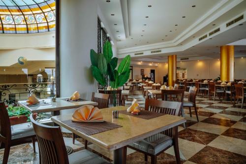 a restaurant with tables and chairs and a ceiling at Grand Oasis Resort in Sharm El Sheikh