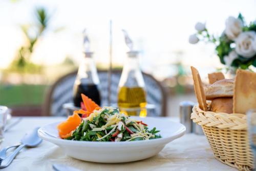 a plate of food on a table with a bowl of food at Grand Oasis Resort in Sharm El Sheikh