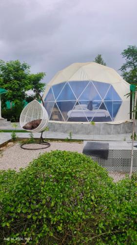 a large tent with a chair in front of it at Nature life farm in Chonp
