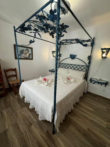 a bedroom with a bed with a blue canopy at Lugar das Andorinhas in Albufeira