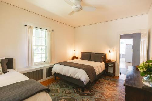 a bedroom with two beds and a window at Private Downtown Sunny Retreat w/ Spacious Balcony in Lewisburg
