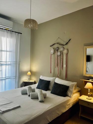 a bedroom with a large bed with pillows on it at Agali Apartments in Tinos